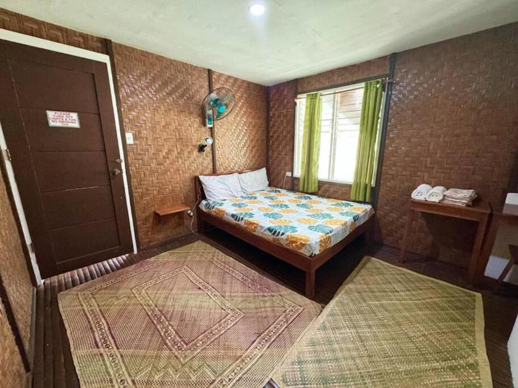 a small bedroom with a bed and a window at White Knight Double Family Room in San Juan