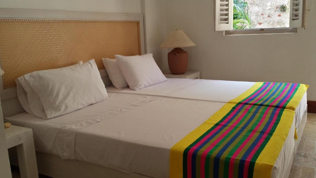 Een bed of bedden in een kamer bij Casa Pizarro Hotel Boutique