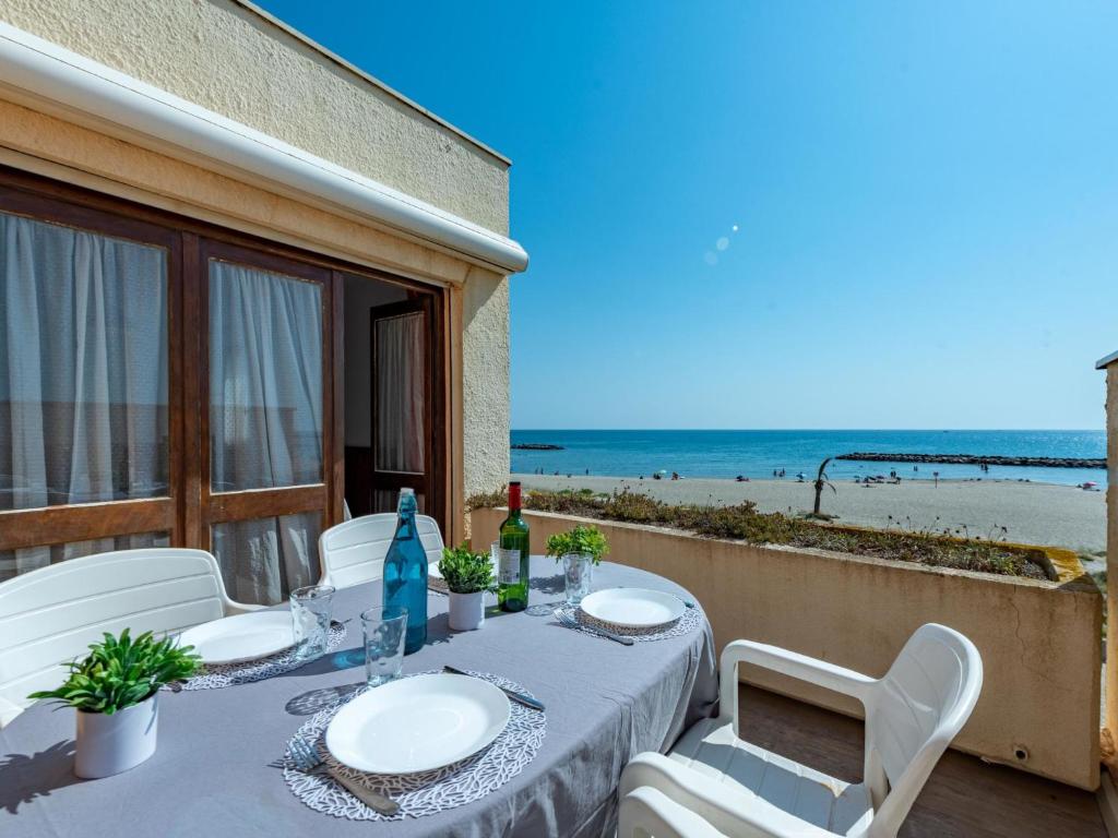 une table sur un balcon avec vue sur la plage dans l'établissement Apartment le Grand Large-10 by Interhome, au Barcarès
