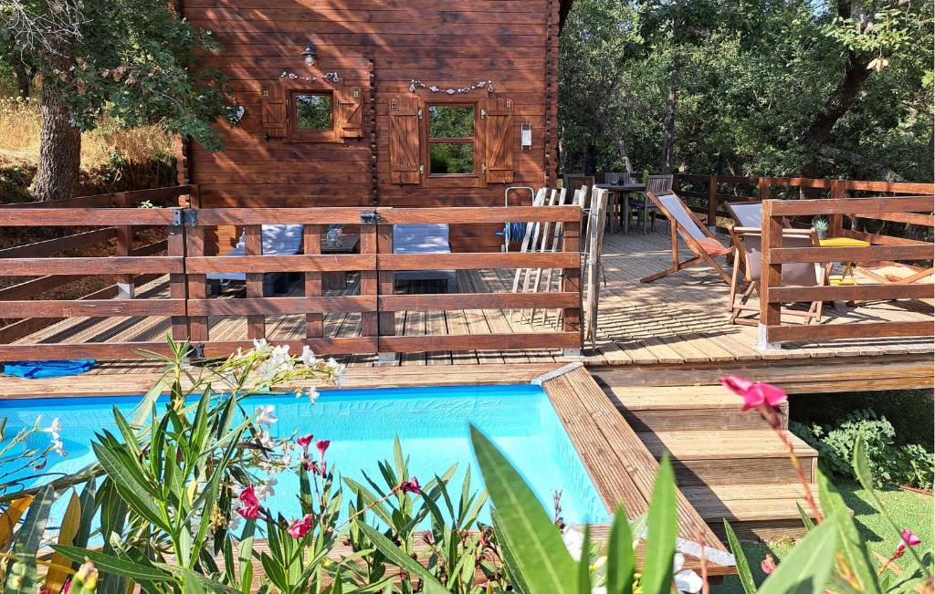 a log cabin with a wooden deck and a swimming pool at Amazing Home In La Garde-Freinet in La Garde-Freinet