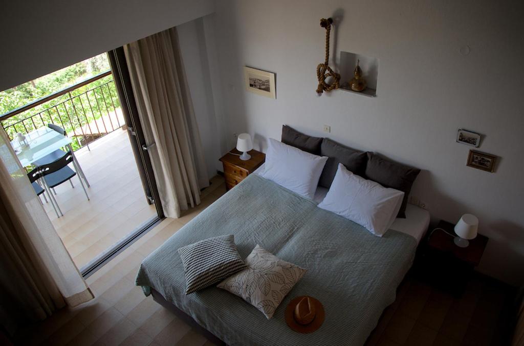 a bedroom with a large bed and a balcony at Villa Anna in Megali Ammos