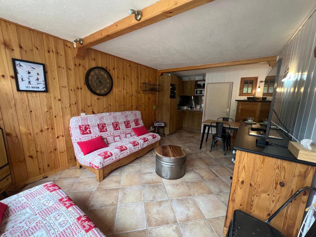 a living room with a couch and a kitchen at Très beau studio rénové Puy Saint Vincent 1600 in Puy-Saint-Vincent