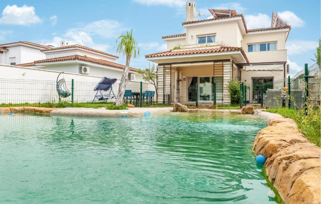 a swimming pool in front of a house at Beautiful Home In Bollullos De La Mitaci in Bollullos de la Mitación