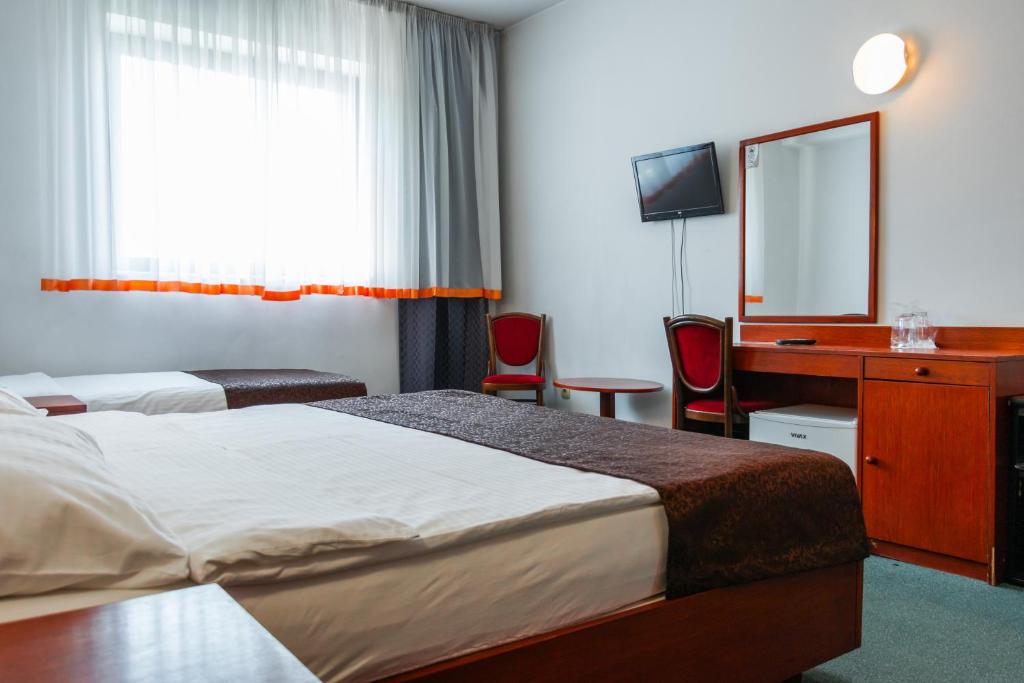 Postel nebo postele na pokoji v ubytování Hotel Saraj