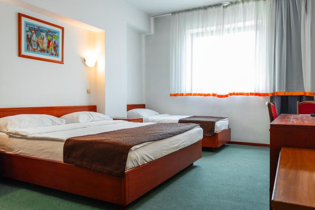 Postel nebo postele na pokoji v ubytování Hotel Saraj
