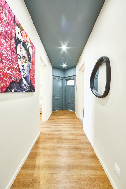 un couloir avec un mur peint et un miroir dans l'établissement RI 2 - F3 Appartement familial spacieux et chaleureux 1 à 6 personnes, à Mulhouse