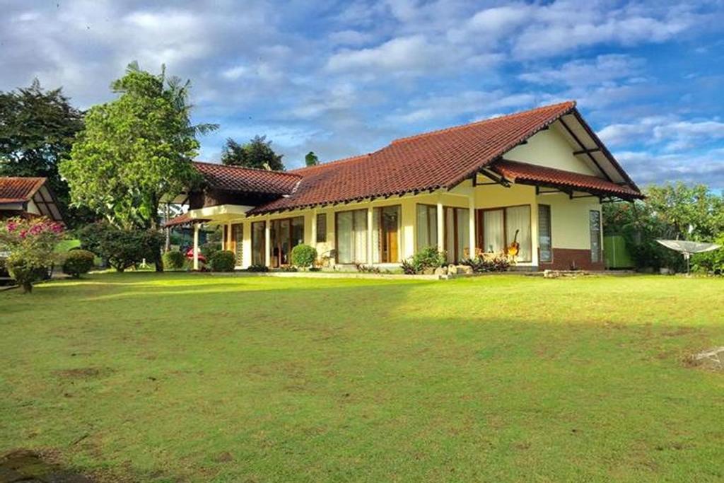 a house with a large yard in front of it at Nataka Green in Kopo 2
