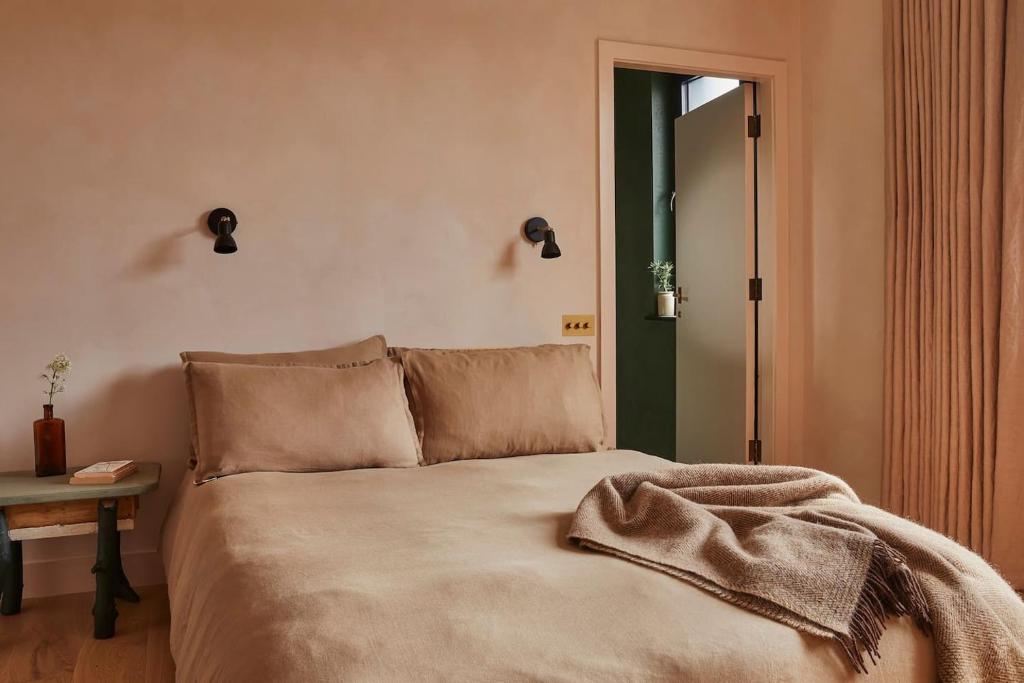 a bedroom with a bed with a blanket on it at Yarn - Elmo Deluxe Suite in Ballycastle