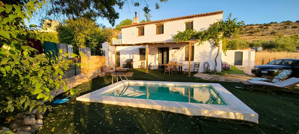 a swimming pool in the yard of a house at Casa Rural Puente de la Vicaria by Jaxun in Yeste