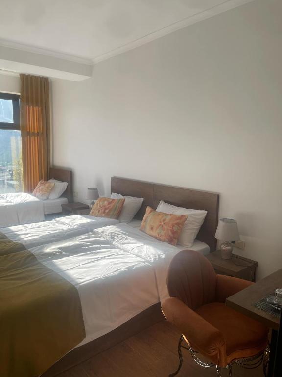 Postel nebo postele na pokoji v ubytování Melodia KAZBEGI