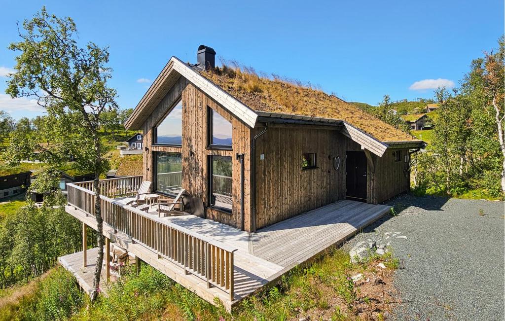 a house with a deck with a grass roof at Cozy Home In Rauland With Sauna in Rauland
