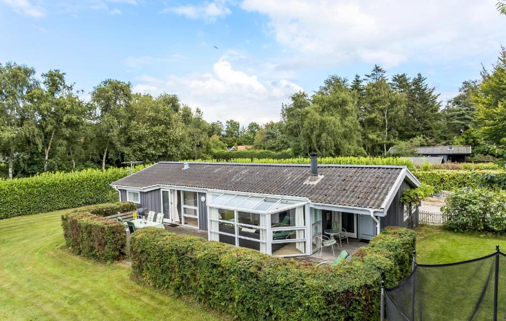 an exterior view of a house with a garden at Beautiful Home In Tranekær With Wifi in Tranekær