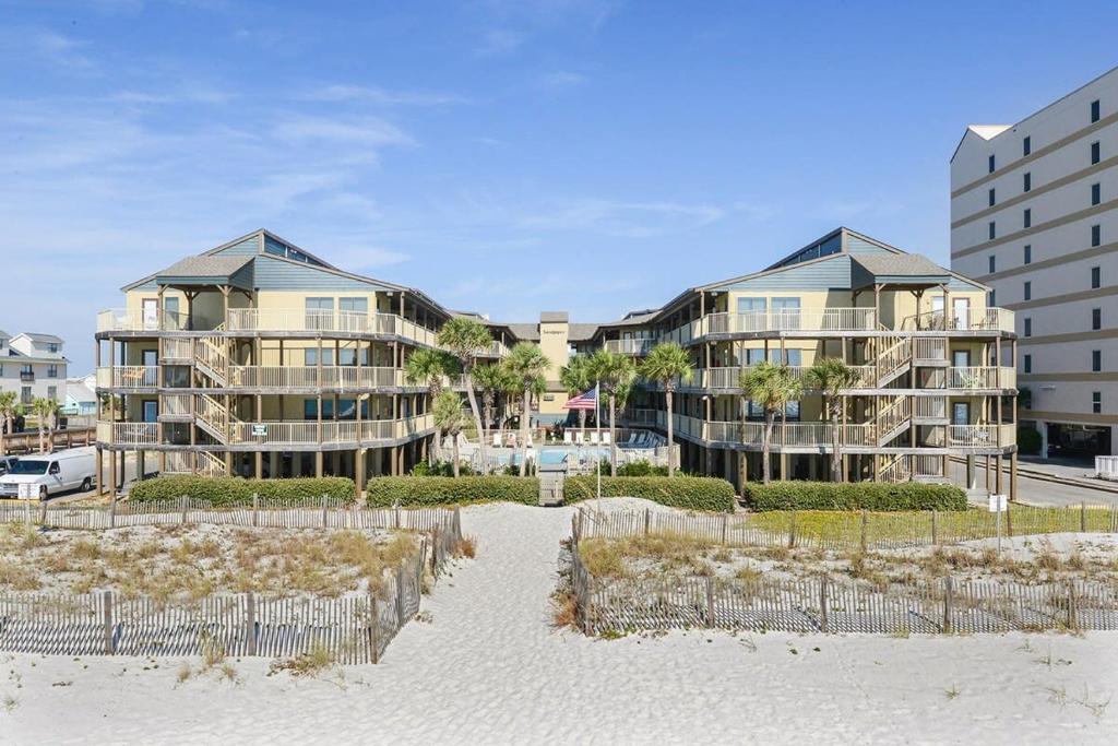 a row of apartment buildings on the beach at Sandpiper 1C- Stylish Gulf-side affordable in Gulf Shores