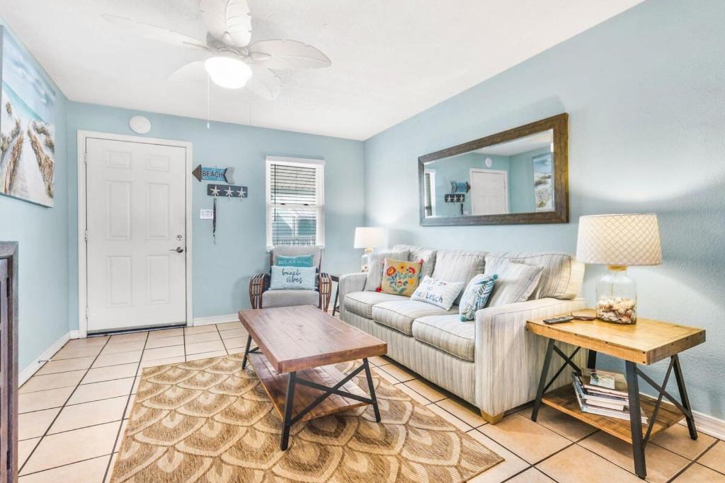 a living room with a couch and a table at Sunrise Village 215- 2BR 1BA gulf front sleep 6 in Gulf Shores