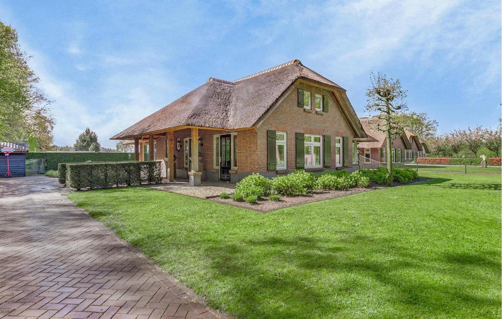 a large brick house with a grass yard at 3 Bedroom Cozy Home In Voorthuizen in Voorthuizen