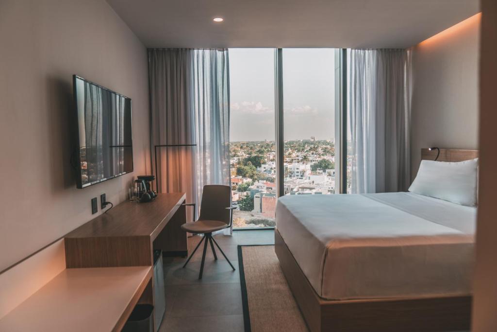 Postel nebo postele na pokoji v ubytování AKEN MIND Mérida Hotel