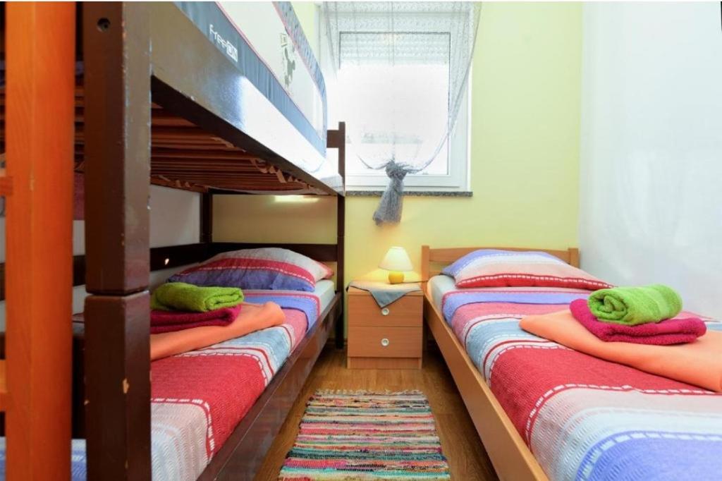 a bedroom with two bunk beds and a window at edwin in Medulin