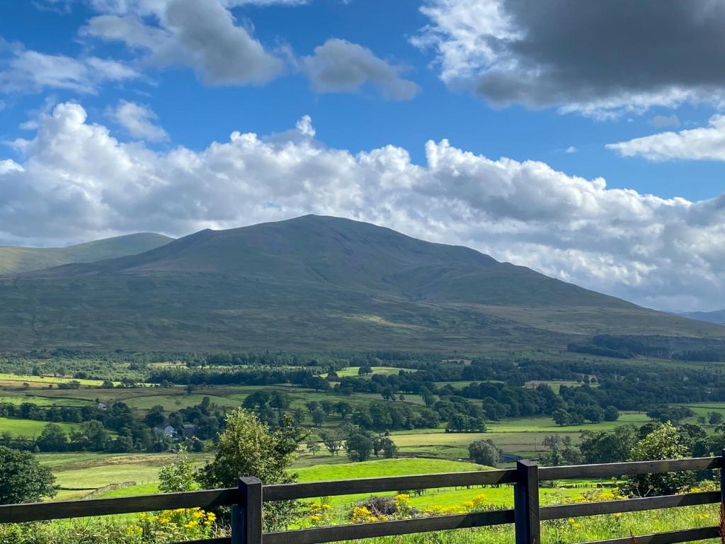 a view of a mountain from a fence at Stunning character cottage near Keswick in Threlkeld