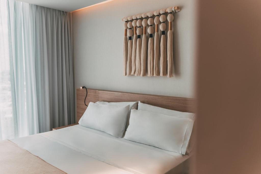Postel nebo postele na pokoji v ubytování AKEN MIND Mérida Hotel