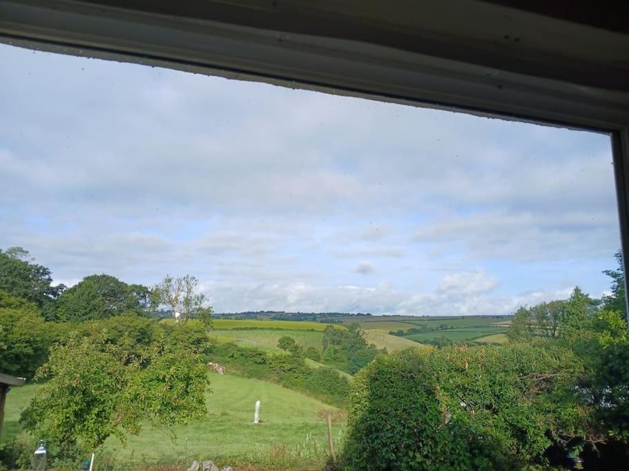 a view of a green field from a window at 2 Little Meadow Cottages in Dartmouth