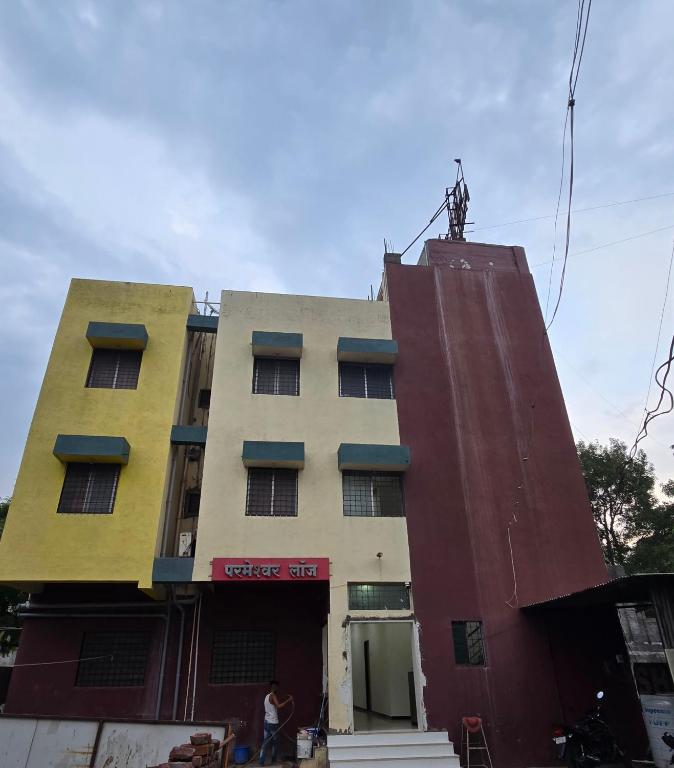 a tall building with a large at Parmeshwar Lodge in Tuljapur