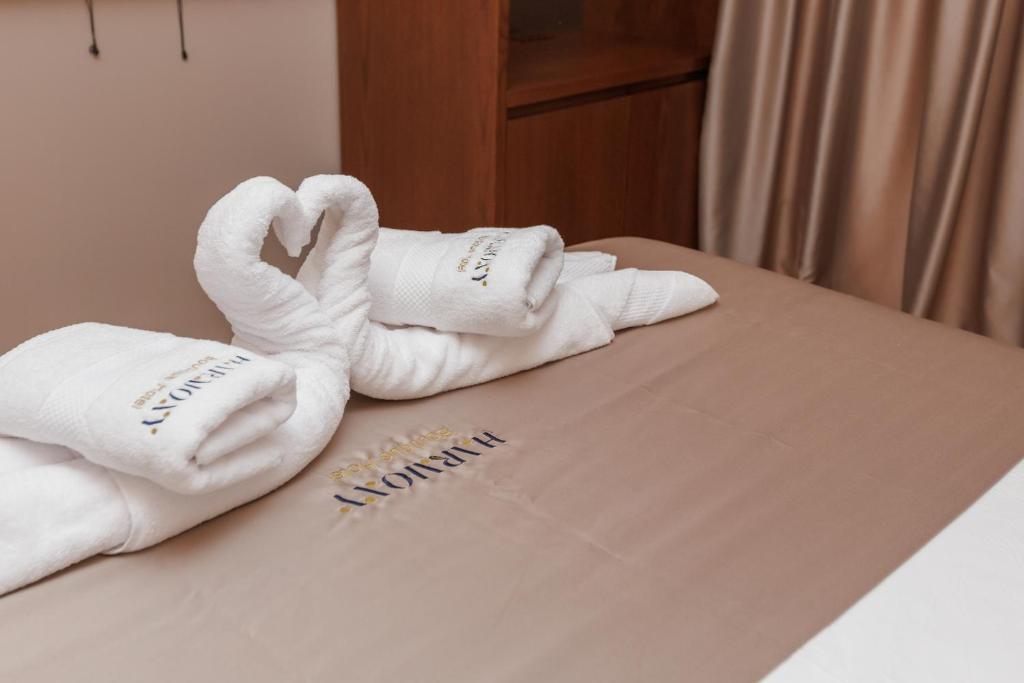 Postel nebo postele na pokoji v ubytování Harmony Boutique Hotel