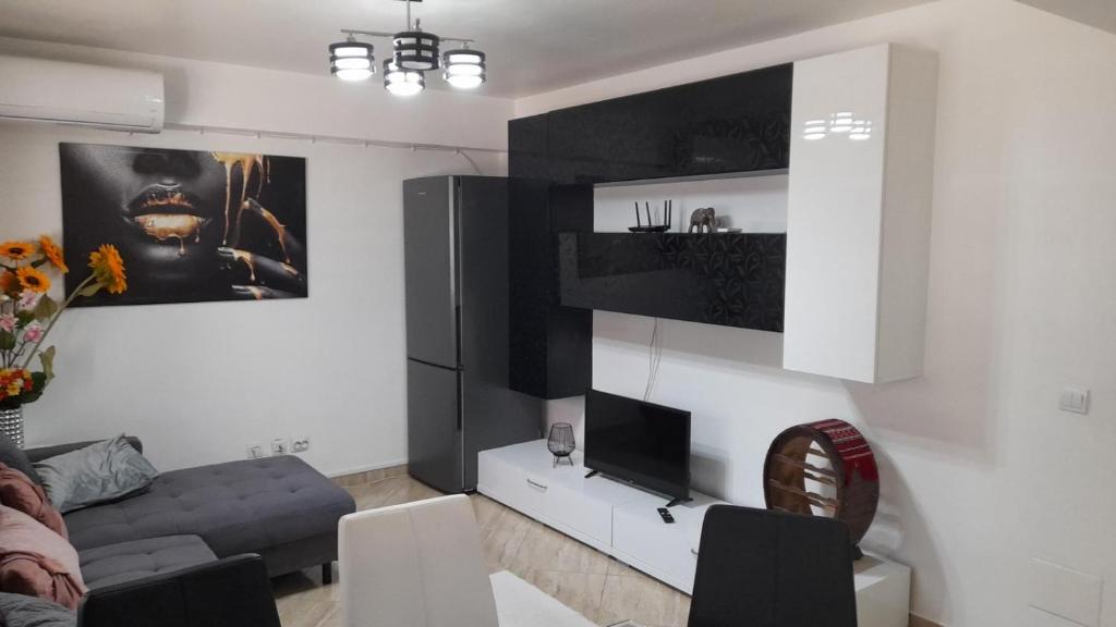 a living room with a couch and a tv at Apartament de lux cu 3 camere in Bacău