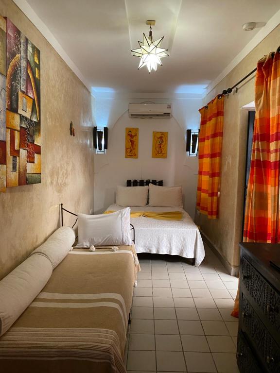 Postel nebo postele na pokoji v ubytování Riad Le Bel Oranger