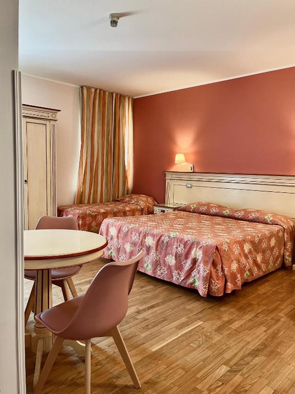 Postel nebo postele na pokoji v ubytování Hotel Matteotti