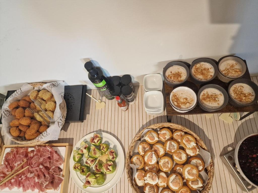 a table with plates of food and a bottle of beer at Hotel Perla in Castiglione della Pescaia