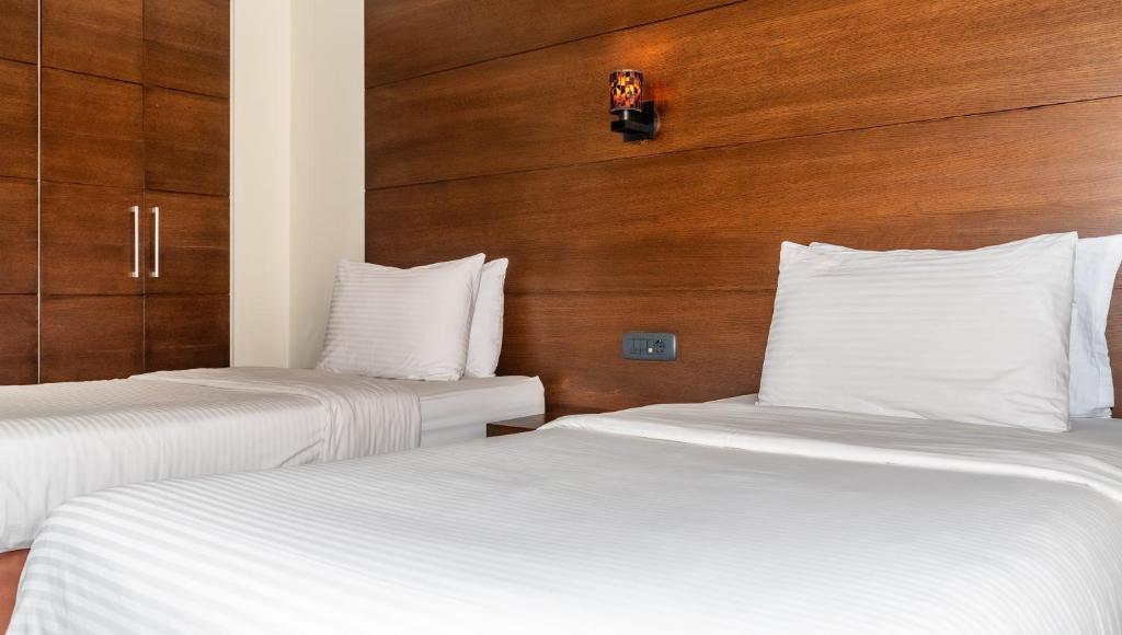 Postel nebo postele na pokoji v ubytování Britannia Suites