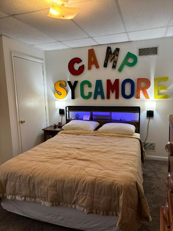 a bedroom with a bed with a sign that says camp software at Welcome to Camp Sycamore in Pittsburgh