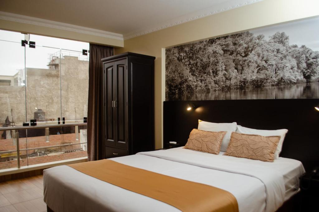 Postel nebo postele na pokoji v ubytování Hotel María Luisa