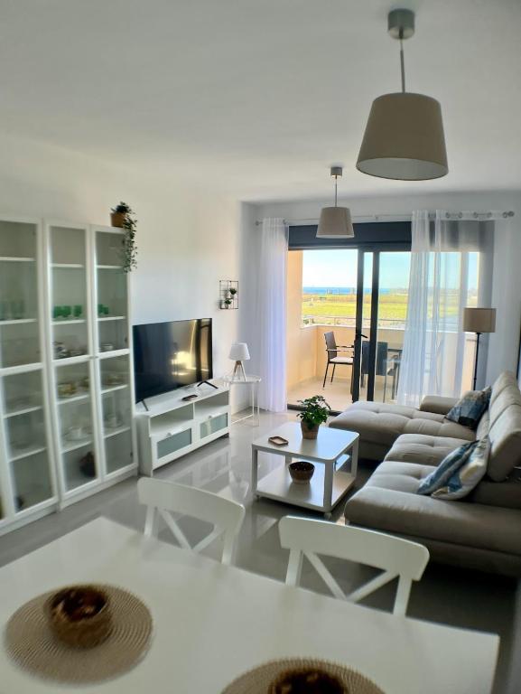 a living room with a couch and a tv at Playa Marinsa Torre del Mar in Torre del Mar