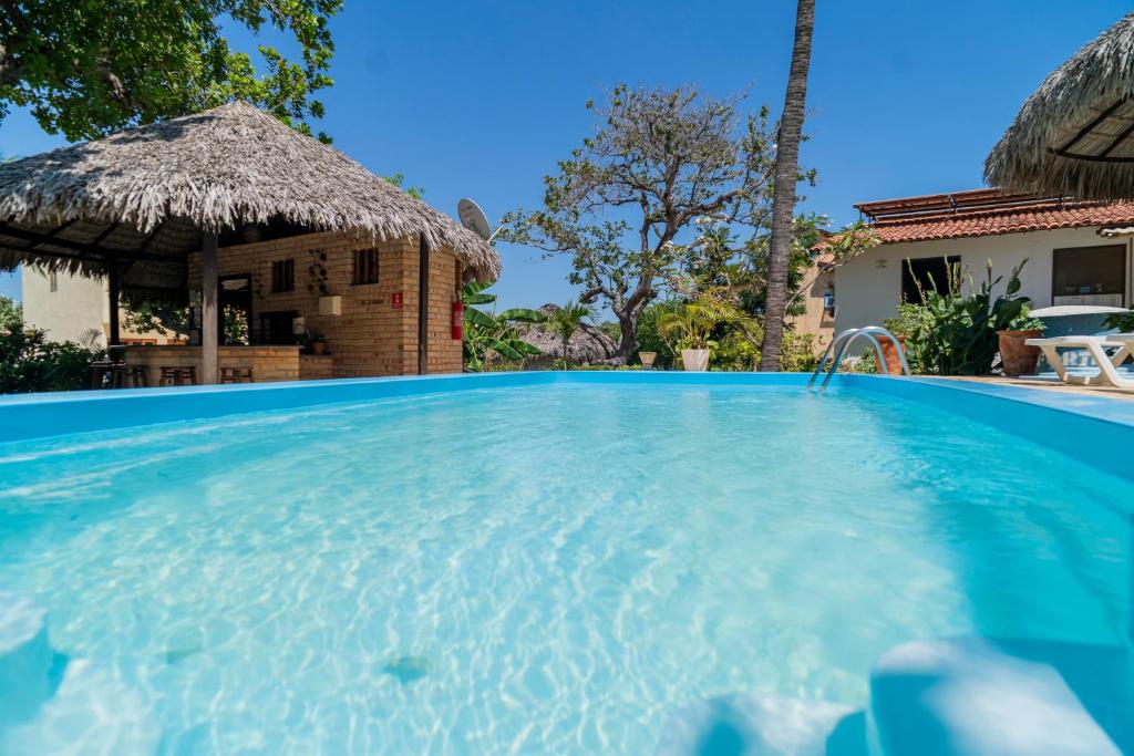 a swimming pool in front of a villa at Casa Suiça Brasileira in Jericoacoara