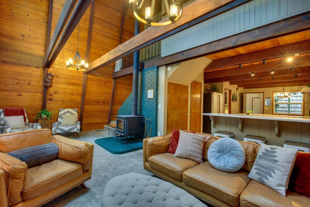 a living room with two couches and a fireplace at Rhododendron Family Cabin Hot Tub and Deck! in Rhododendron
