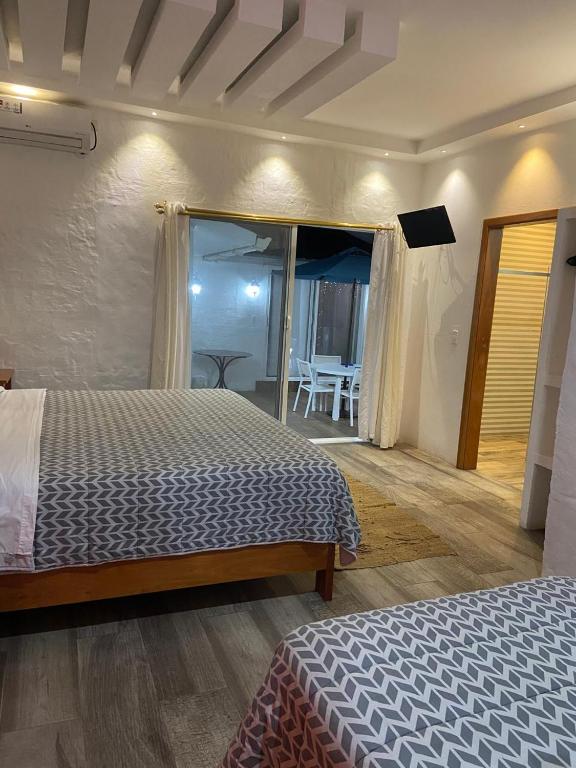 a bedroom with a bed and a view of a room at Suitehome in Bahía de la Academia
