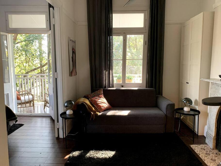 a living room with a couch and a large window at Light filled terrace flat in Sydney