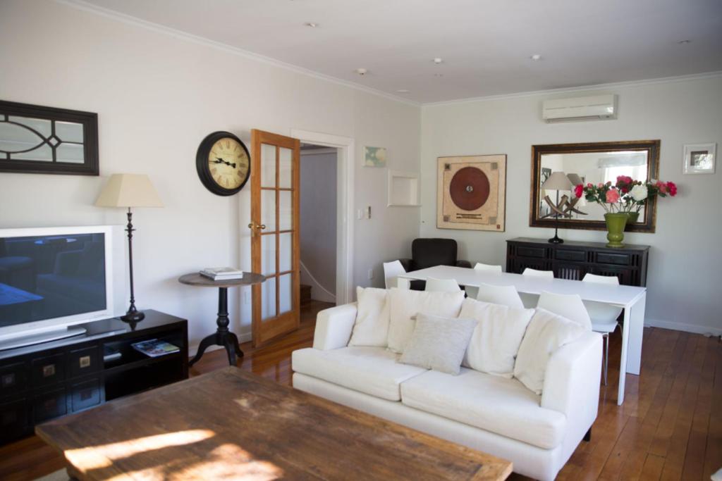 a living room with a white couch and a tv at Apartment 88 in Greytown