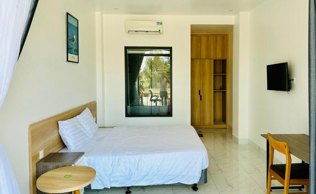 Postel nebo postele na pokoji v ubytování Huy Hoàng Hotel