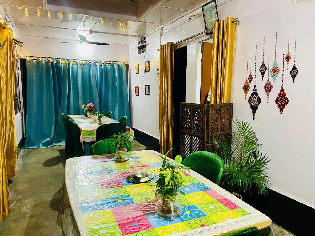 a room with two tables with plants on it at Namaskar Lodge and Homestay in Guwahati