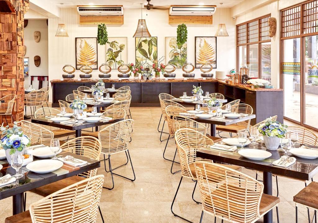 a dining room with tables and chairs in a restaurant at Tag Resort in Coron