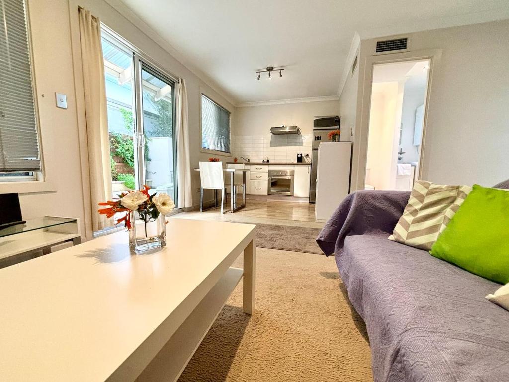a living room with a couch and a table at Urban Oasis Townhouse East Perth in Perth