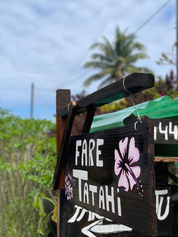 a sign that says fare trainah on a beach at FARE Tatahi in Parea