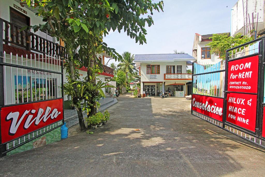 a street in a town with signs on buildings at Villa Consolacion Resort in General Luna