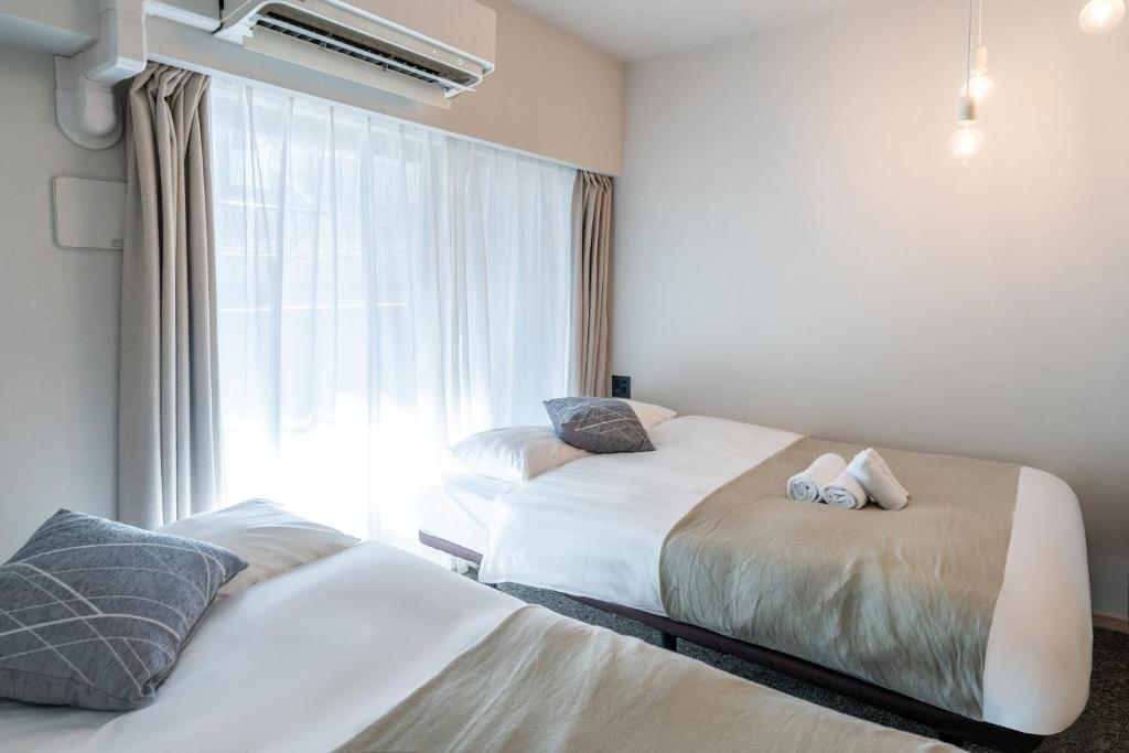 Postel nebo postele na pokoji v ubytování Apartment Hotel 11 Shinsaibashi