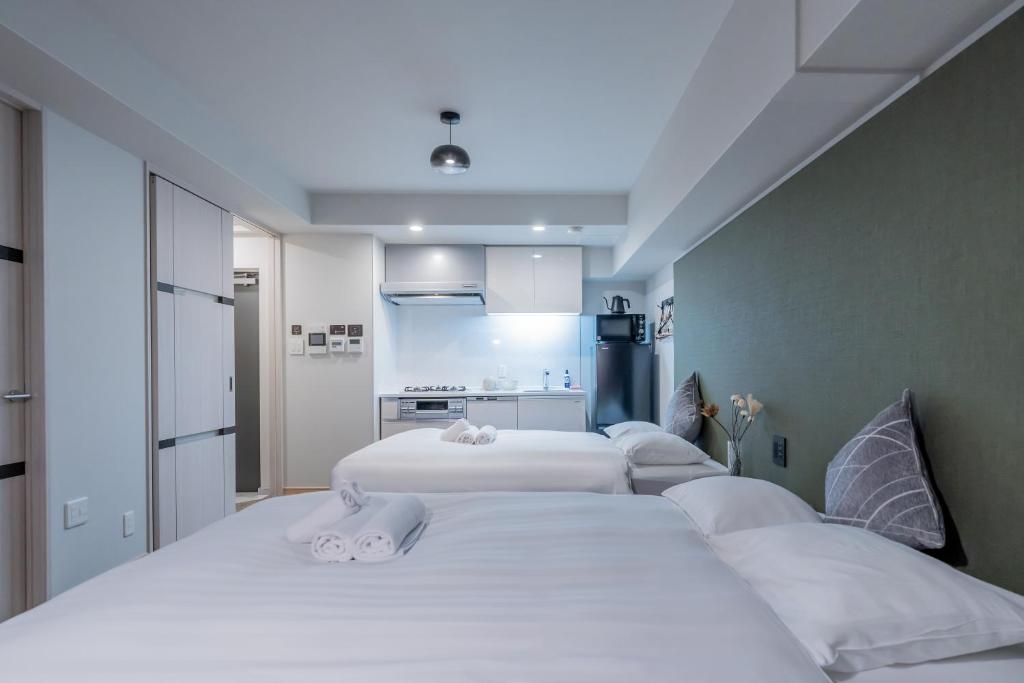 Postel nebo postele na pokoji v ubytování Apartment Hotel 11 Shinsaibashi