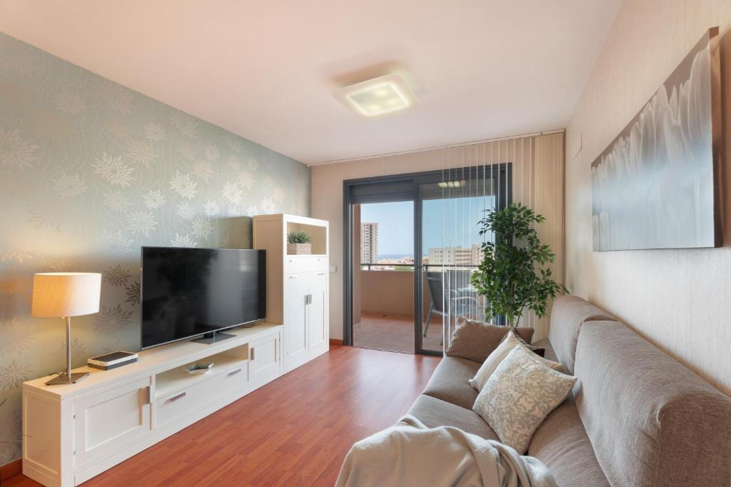 a living room with a couch and a flat screen tv at Apartamento Vista Paraiso in Adeje