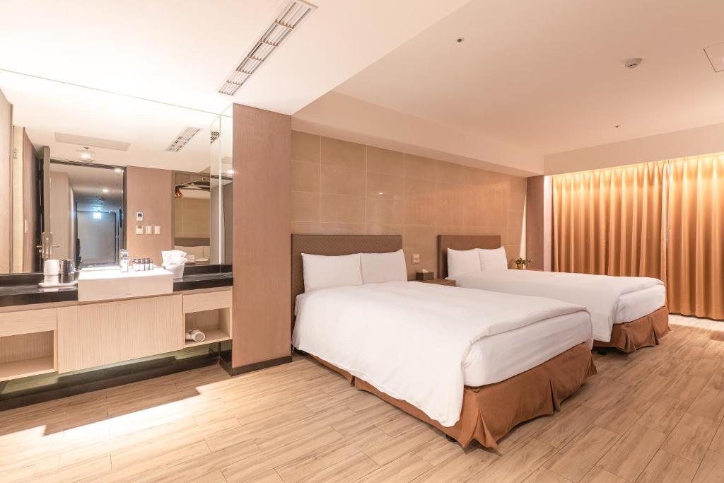 Postel nebo postele na pokoji v ubytování Guide Hotel Taipei Fuxing North
