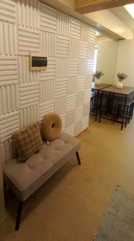 a couch in a room with a wall with a table at Avida Davao Condos, downtown CM Recto Avenue, Davao City in Davao City